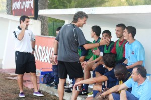 Luis Elcacho saluda a los jugadores del banquillo antes de un encuentro.