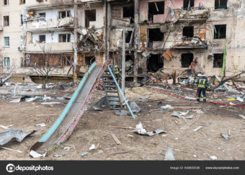 KYIV, UKRAINE - Feb. 25, 2022: War of Russia against Ukraine. A residential building damaged by an enemy aircraft in the Ukrainian capital Kyiv