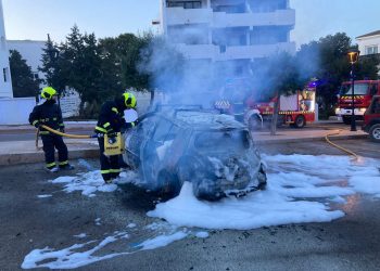 Imagen de la labor de los bomberos de Formentera apagando las llamas en el coche.