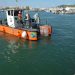 Un barco de los que hacen limpieza de las aguas del puerto de Ibiza de la APB