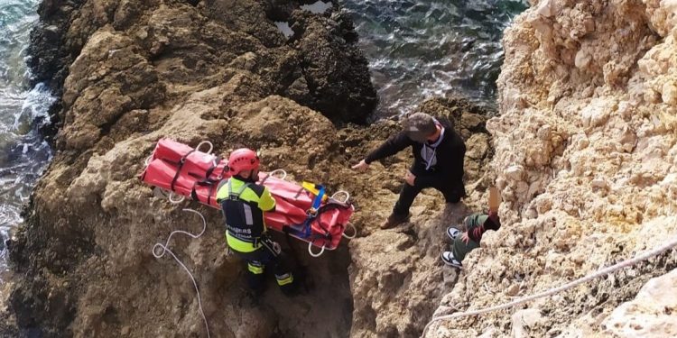 Uno de los bomberos llega con la camilla al lugar donde está el menor. Bombers d'Eivissa