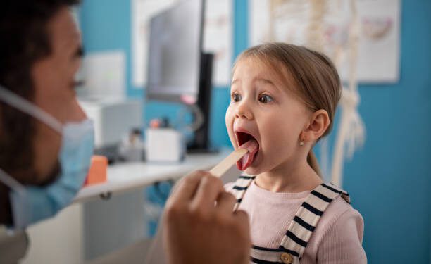 Imagen de archivo de una niña en el pediatra. IStock