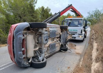 El coche volcado se quedó atravesado en la vía y ha tenido que ser retirado por operarios de Grúas Ibiza.