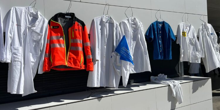 Uniformes médicos cuelgan de la fachada del hospital a modo de protesta simbólica, este lunes en Can Misses. Foto: Simebal