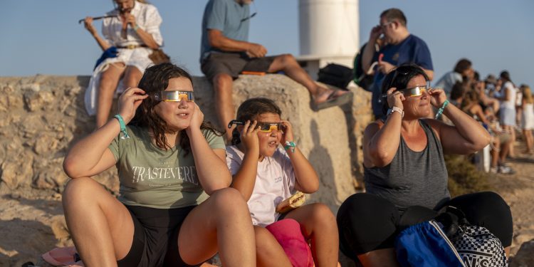 Personas mirando el eclipse solar en Formentera con gafas homologadas. Foto de Paco Natera